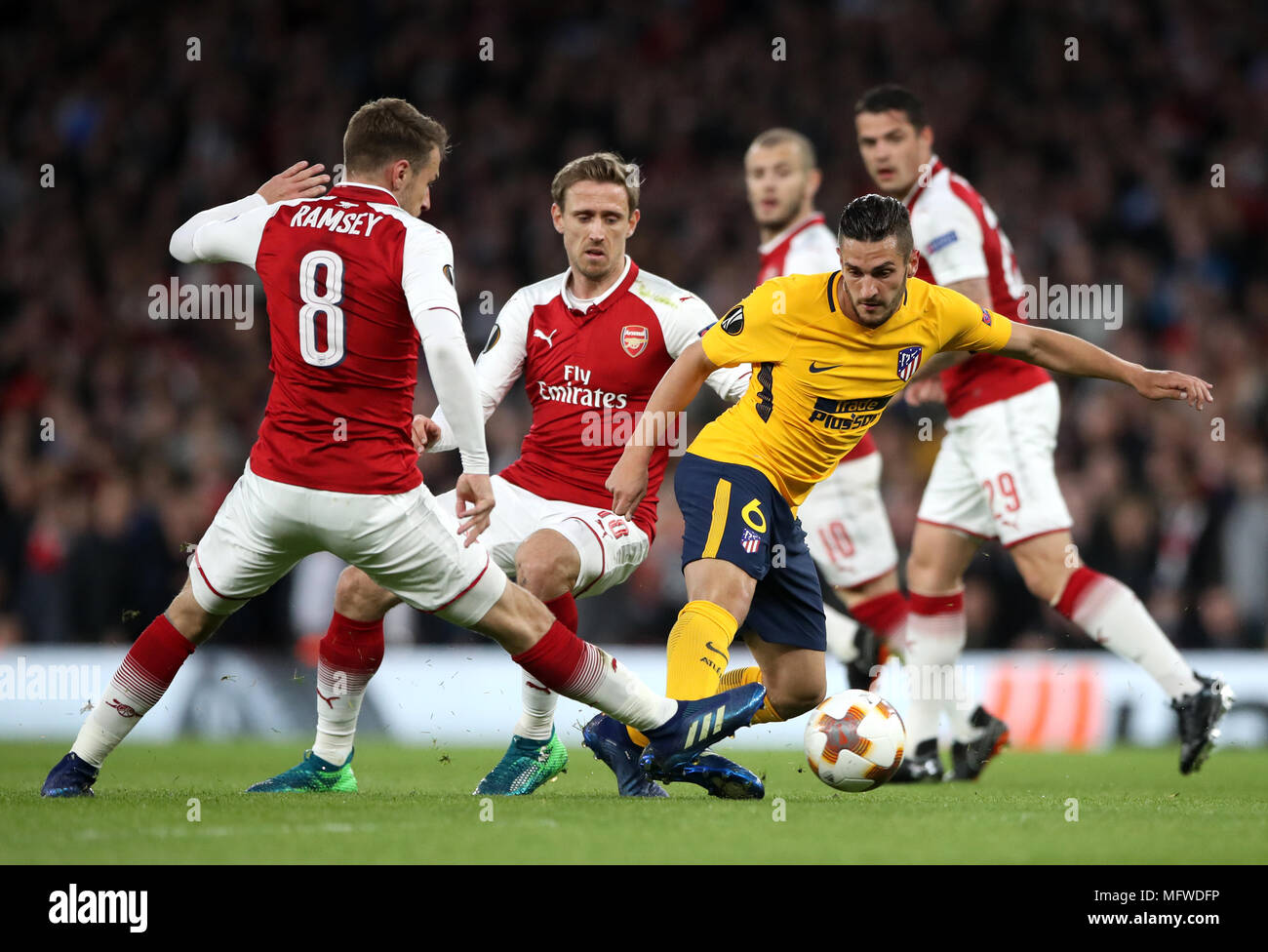 Arsenal's Aaron Ramsey (left) and Atletico Madrid's Jorge Koke battle for the ball during the UEFA Europa League semi final, first leg match at the Emirates Stadium, London. Stock Photo