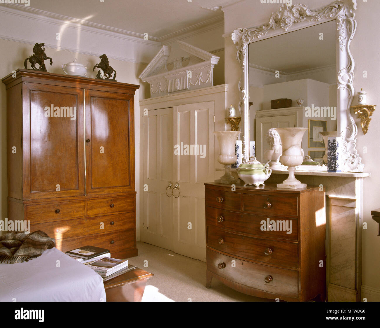 A Traditional White Bedroom With Freestanding Wardrobe And Chest