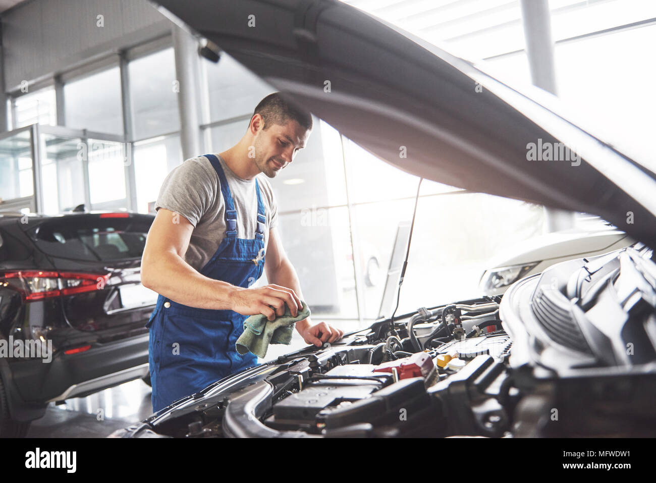 Auto mechanic working in garage. Repair service Stock Photo