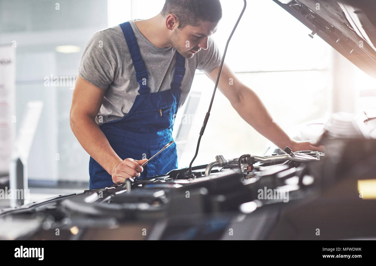 Auto mechanic working in garage. Repair service Stock Photo