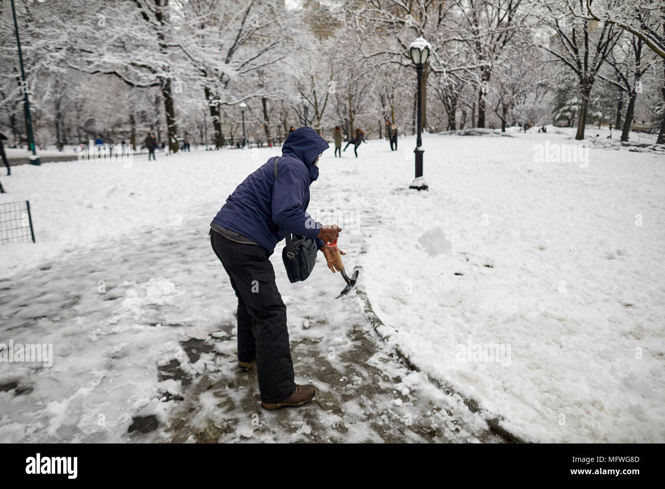 Manhattan in New York City  Easter snow covers Grand Central Park, worker clearing paths Stock Photo