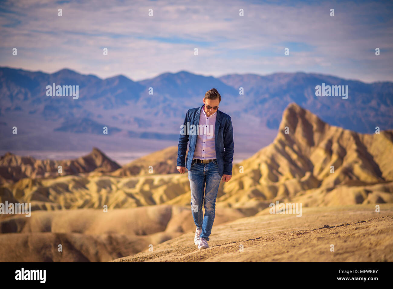 Young man walking alone in the desert of Death Valley Stock Photo