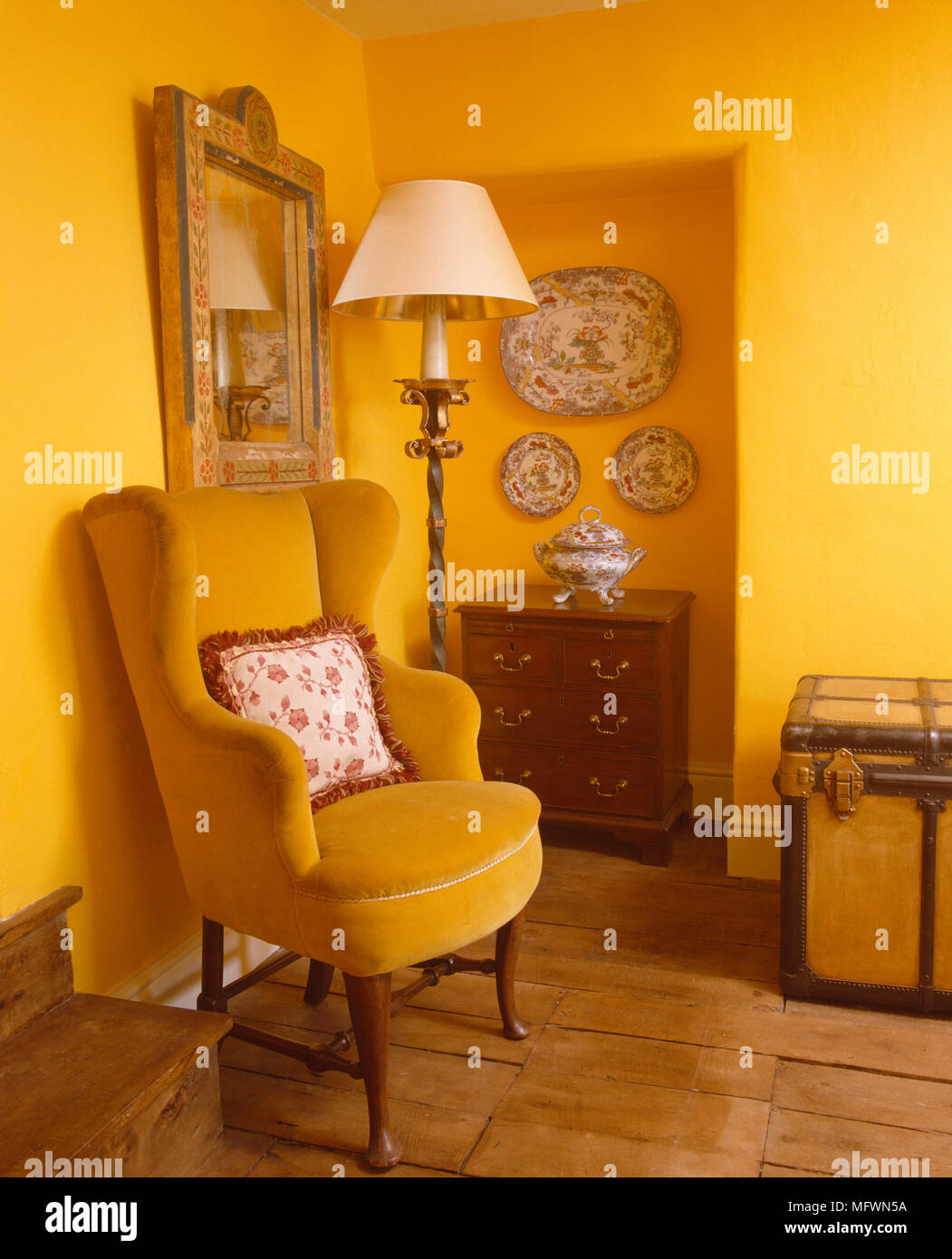 Upholstered Wing Chair Next To Chest Of Drawers In Yellow Sitting