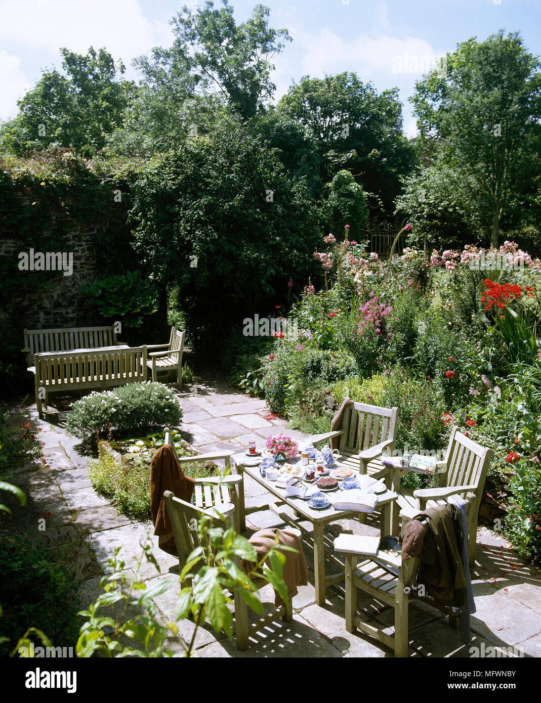 Back Patio With Wooden Outdoor Dining Table And Chairs Bench