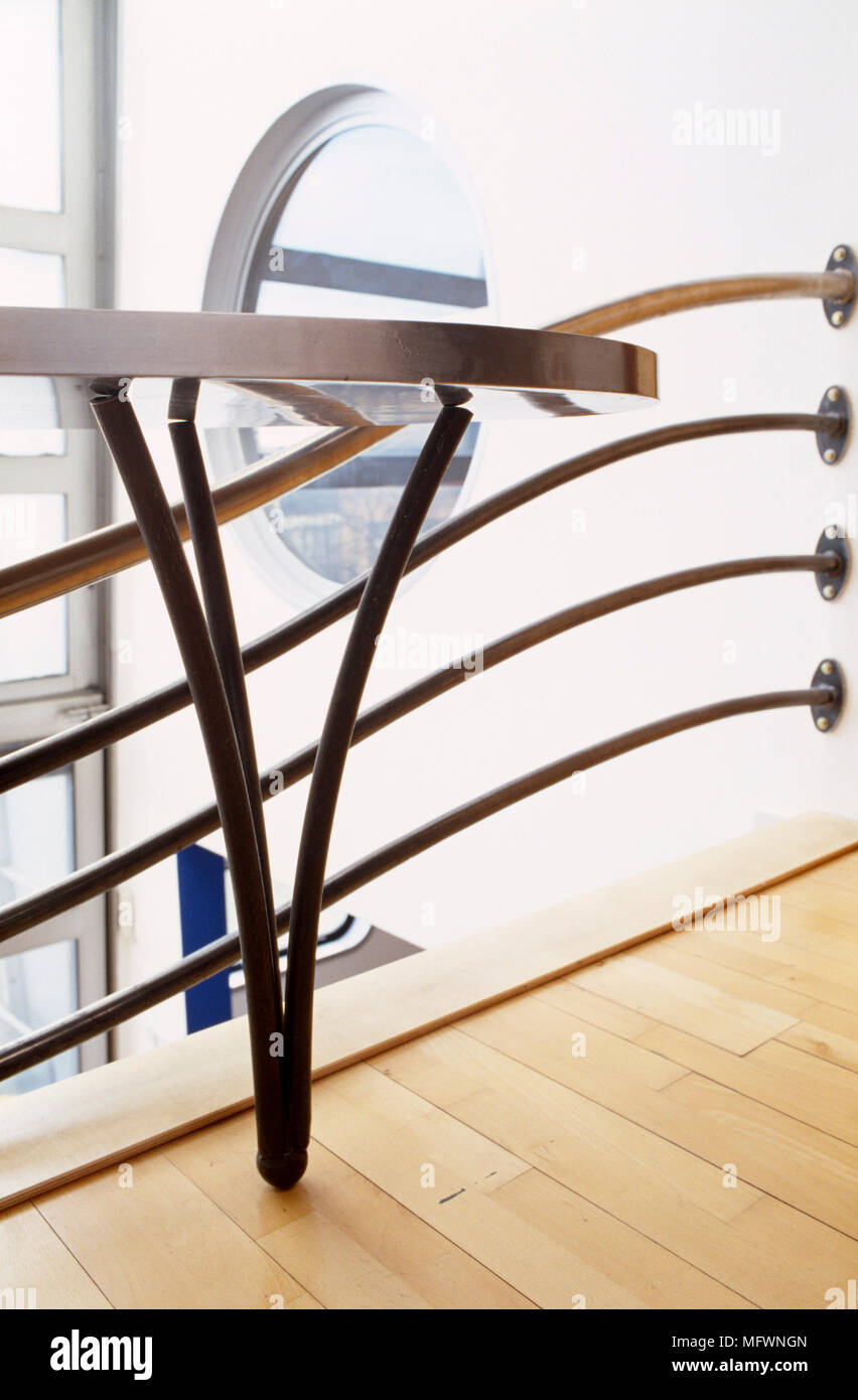 Steel table set on gallery with railing Stock Photo - Alamy
