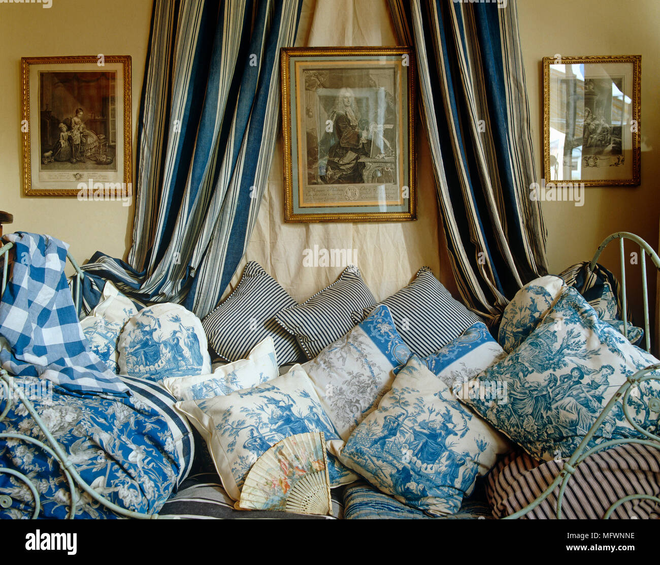 Collection toile de Jouy fabric cushions arranged on daybed Stock Photo