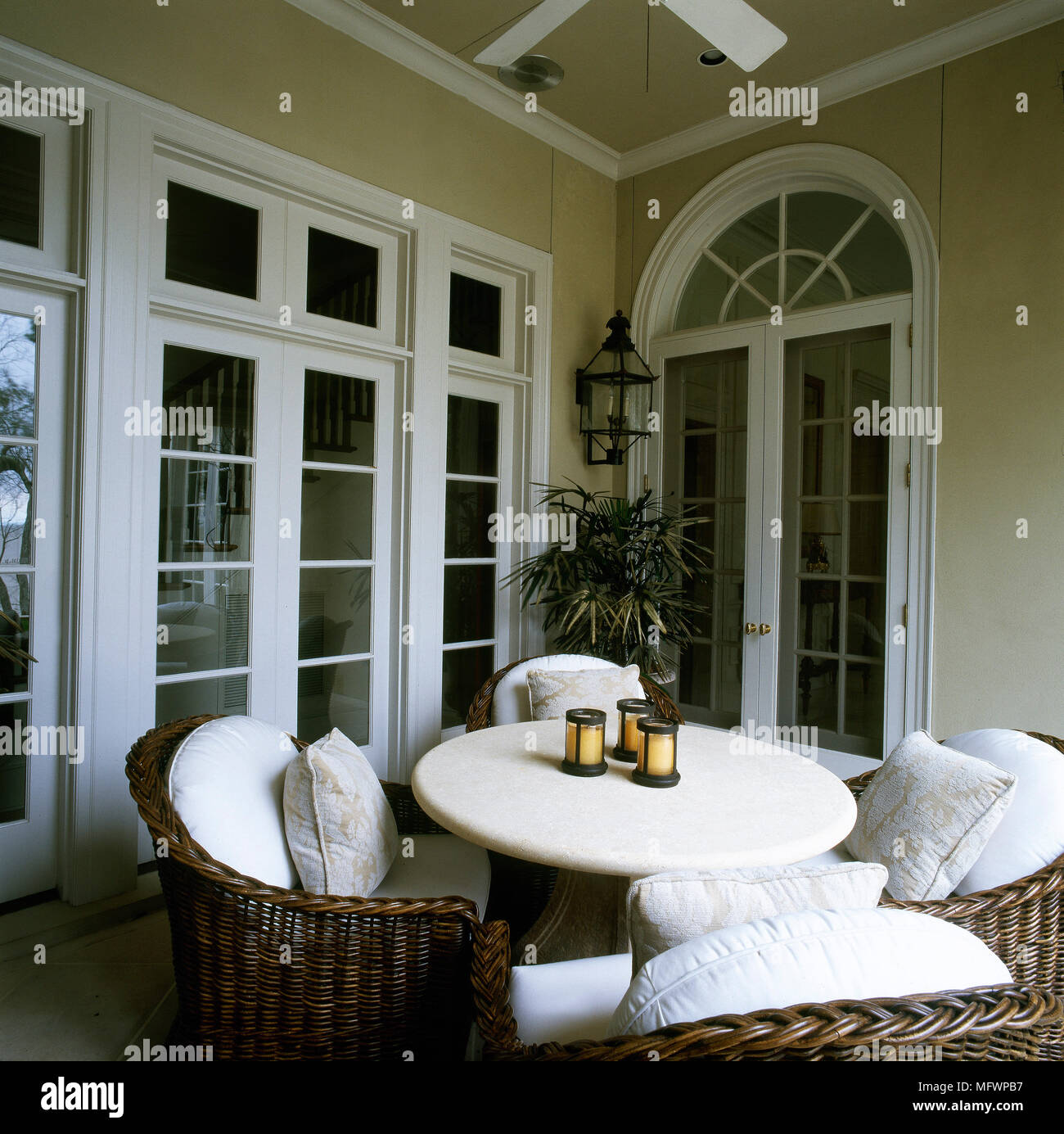 Conservatory with dining table and cane wicker chairs Stock Photo Alamy