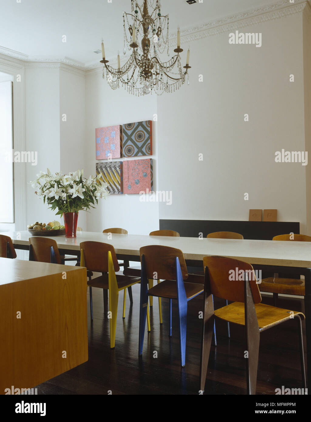 Dining Room With Antique Chandelier Above Dining Table With Wooden Chairs With Canvas Artwork On Wall Stock Photo Alamy