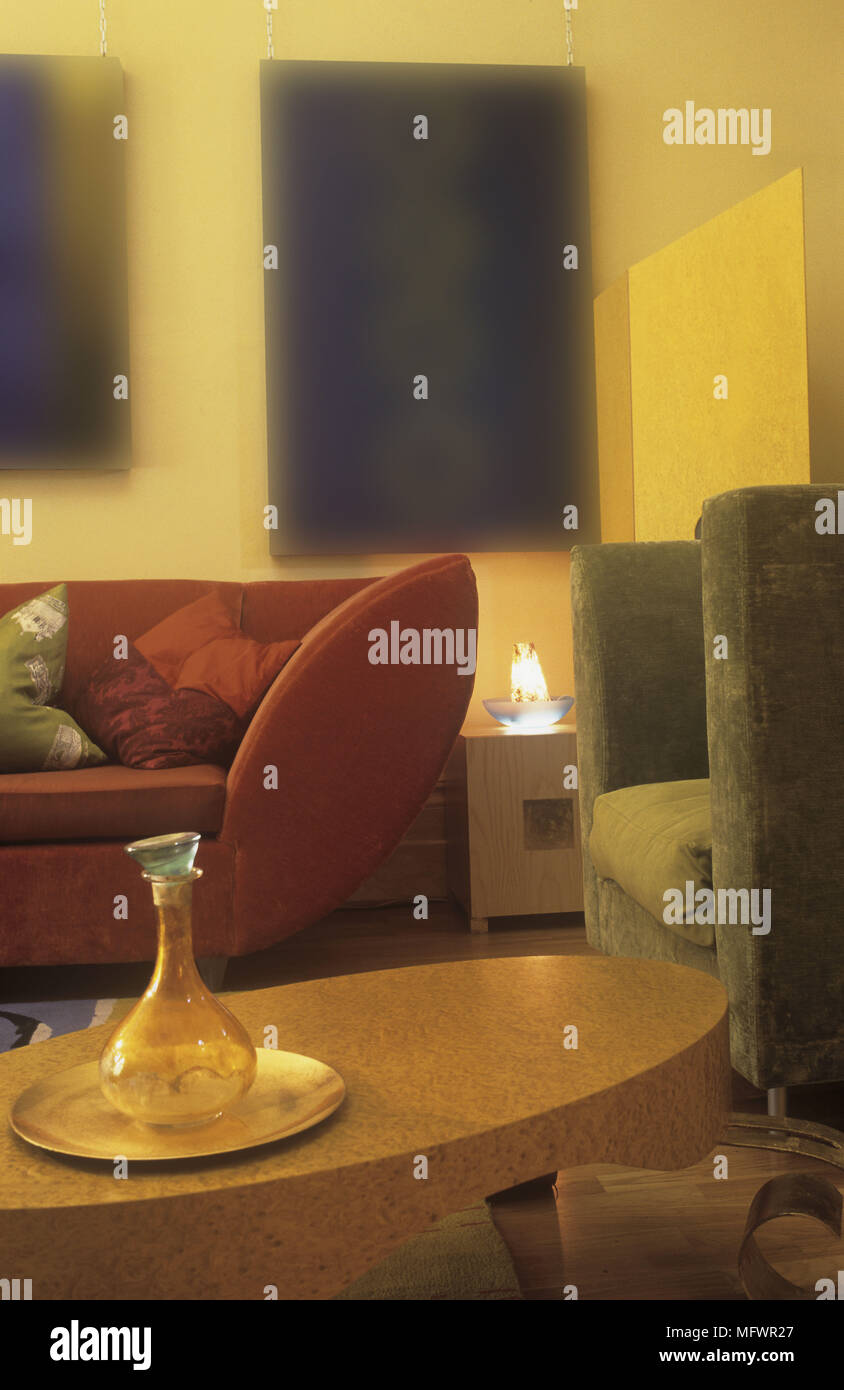 Oval Shaped Coffee Table In Front Of Sofa And Armchair Stock Photo