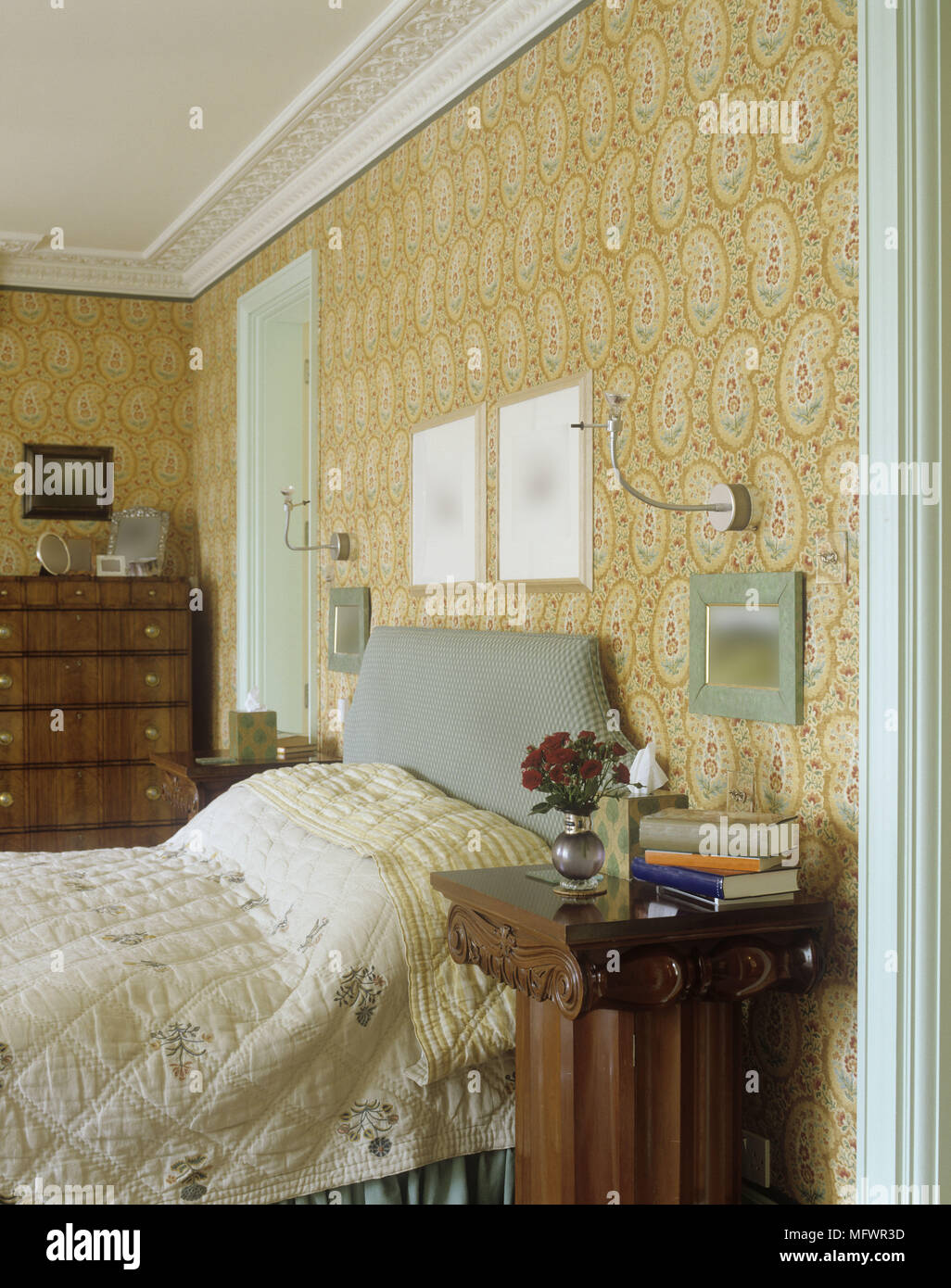 Bed In Bedroom With Patterned Wallpaper And Wooden Bedside