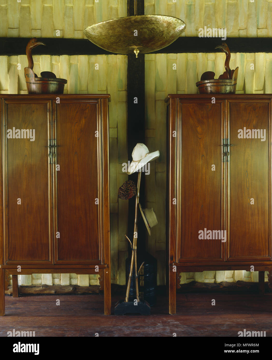 Fishing Equipment And Hats In Between Two Mahogany Cabinets Stock