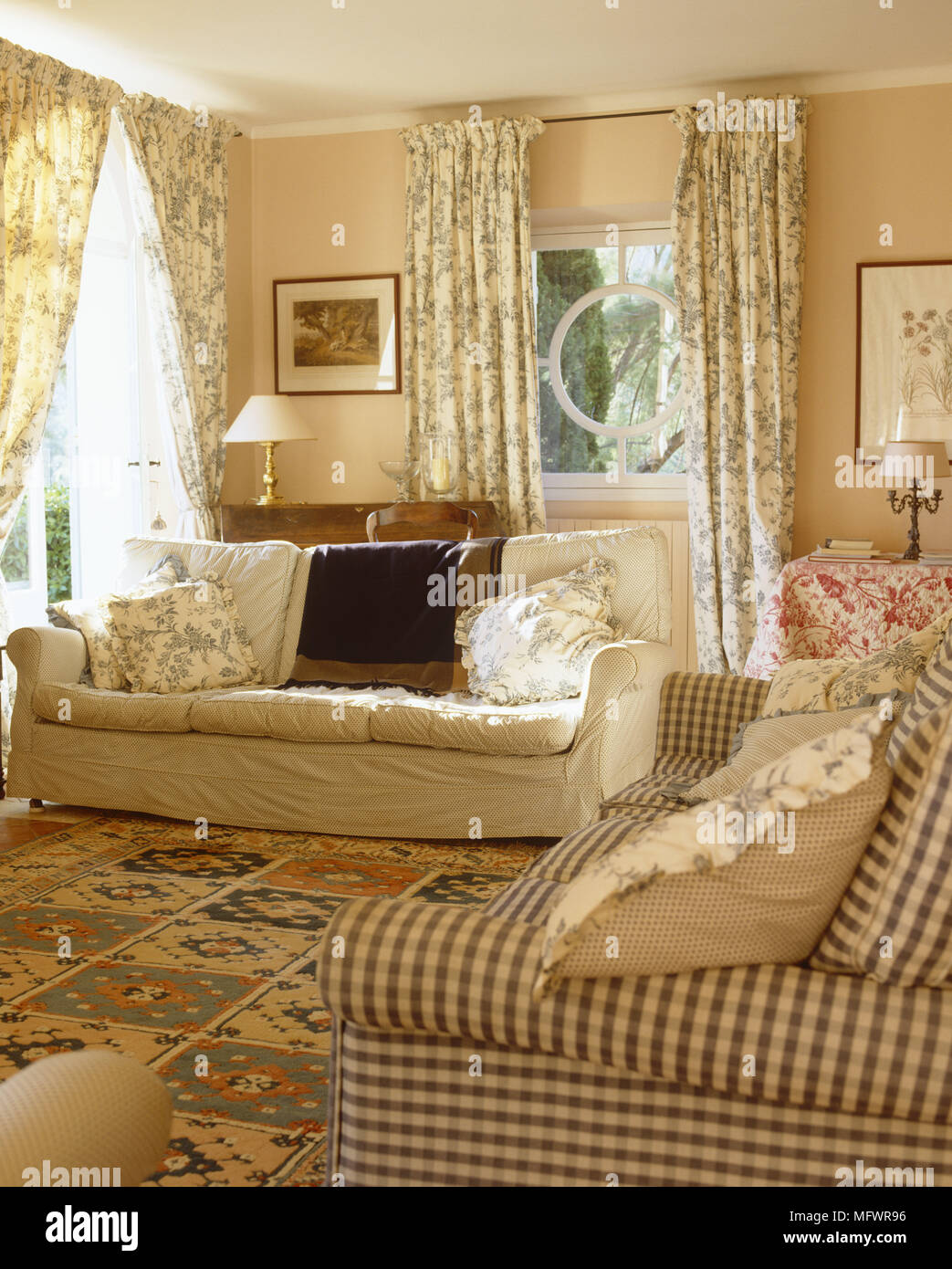 Upholstered sofas facing each other in traditionally decorated sitting room Stock Photo