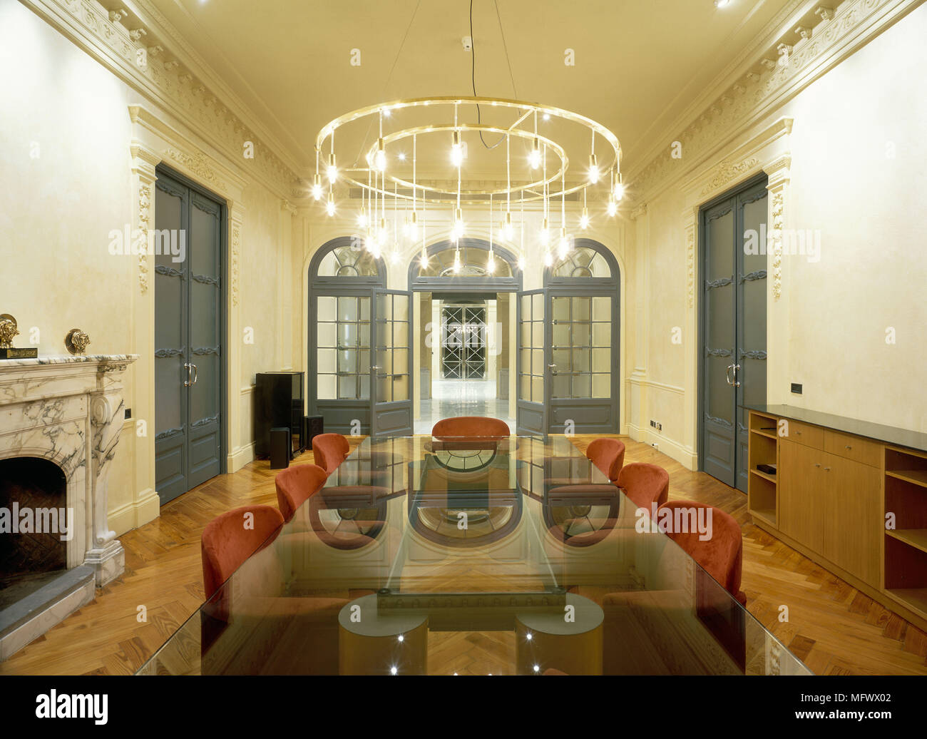 View Of An Elegant Chandelier Lighting Up A Conference Room Stock Photo view-of-an-elegant-chandelier-lighting-up-a-conference-room-stock-photo