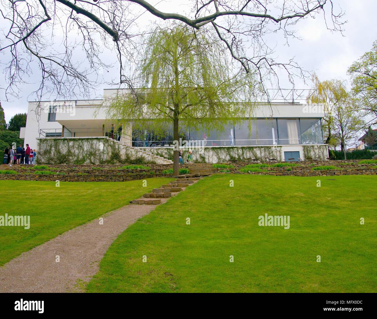 BRNO, CZECH REPUBLIC - APRIL 13, 2018: Garden view of the Villa Tugendhat with visitors on the terrace. Stock Photo