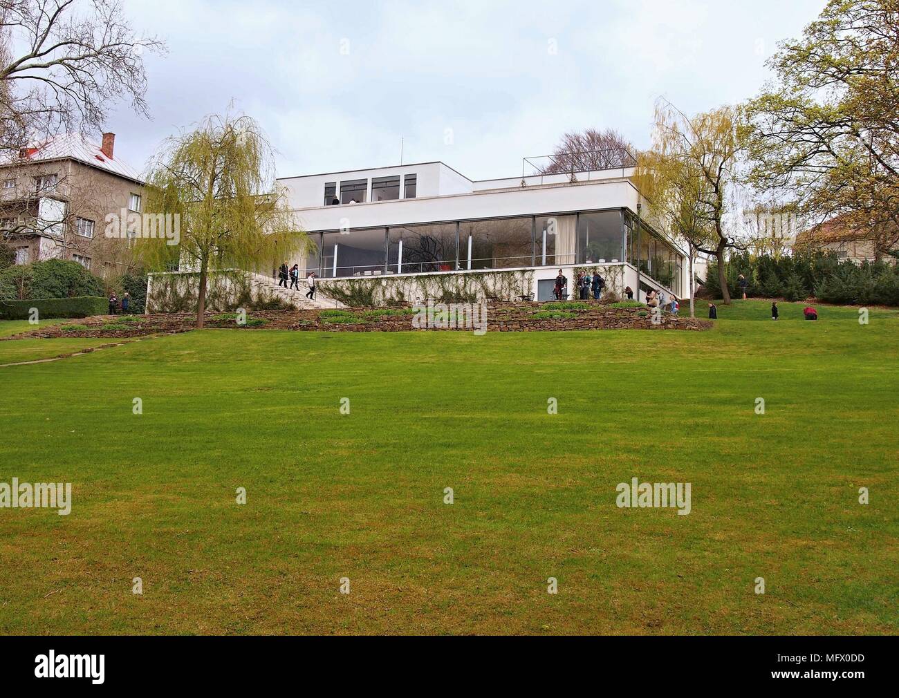BRNO, CZECH REPUBLIC - APRIL 13, 2018: Garden view of the Villa Tugendhat with visitors on the terrace. Stock Photo