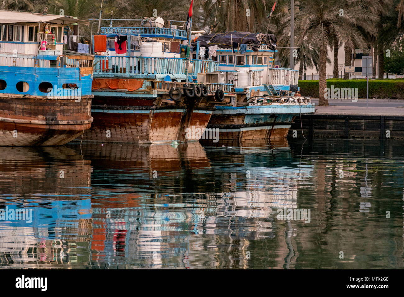 Boats at Port  along Deira's shore of Dubai Creek, UAE. Deira is an old commercial center of Dubai with small shipping and trade boats. Stock Photo