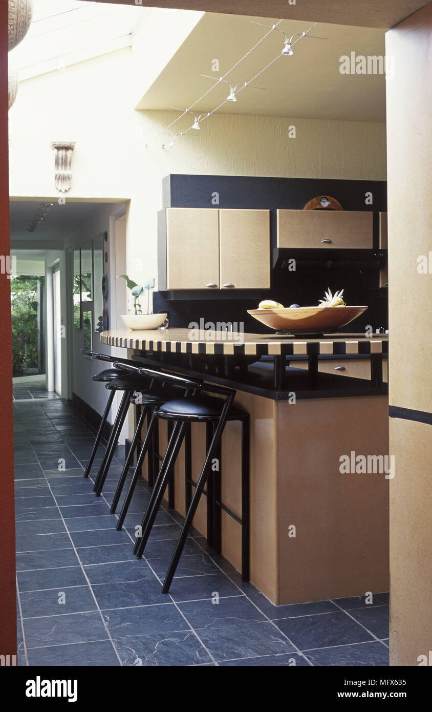 Breakfast bar with bar stools in tiled kitchen Stock Photo Alamy