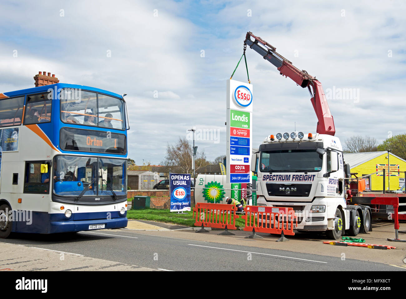 Replacing BP sign with Esso sign at a petrol station in Peterborough