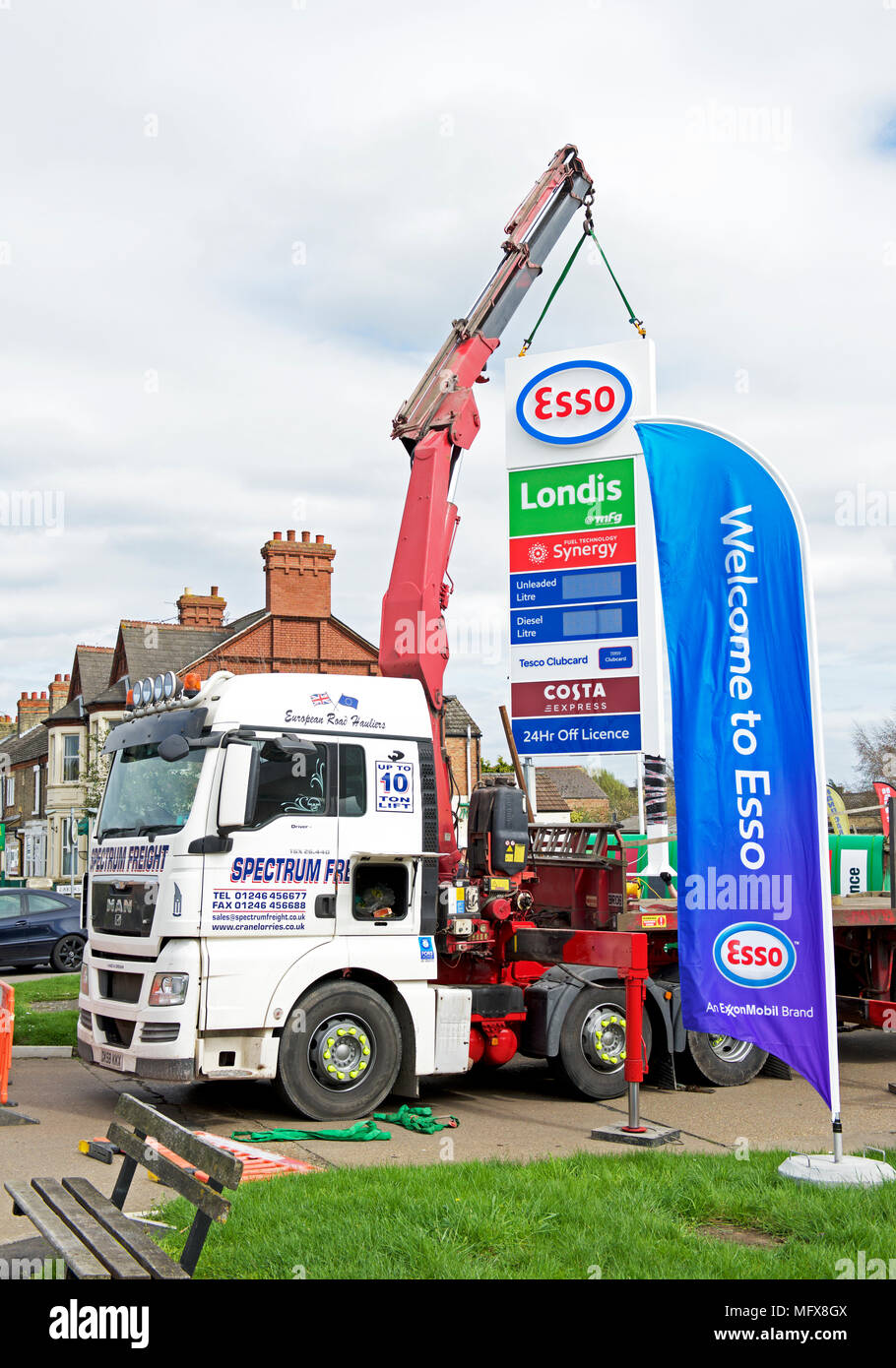 Replacing BP sign with Esso sign at a petrol station in Peterborough
