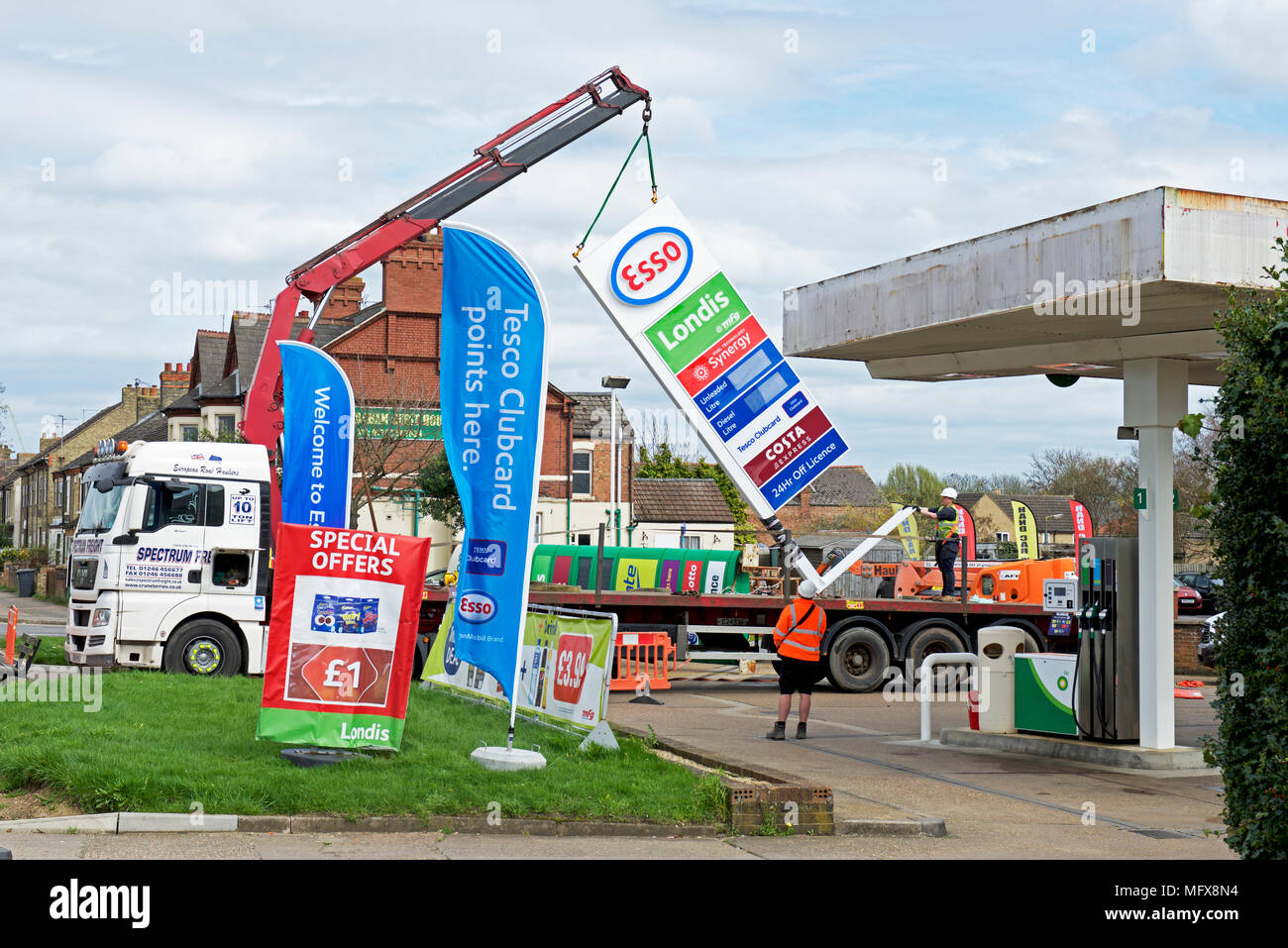 Replacing BP sign with Esso sign at a petrol station in Peterborough, Cambridgeshire, England UK Stock Photo