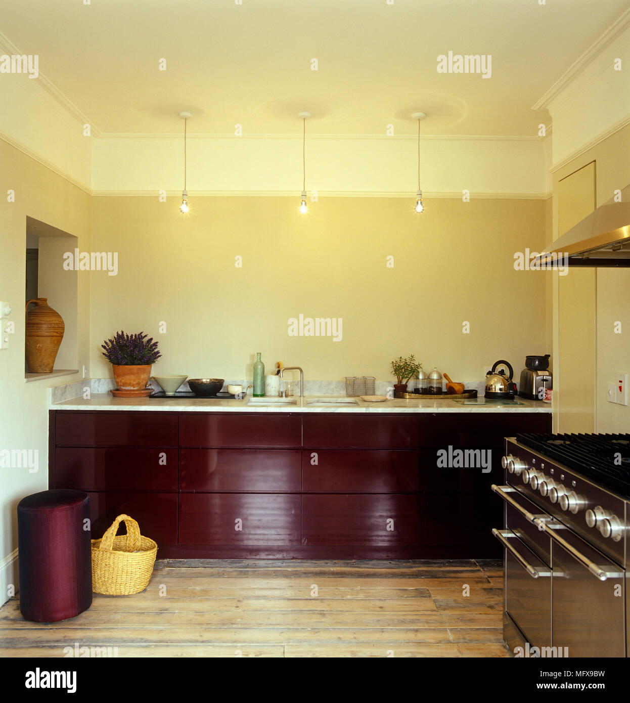 Modern yellow kitchen with wooden units Stock Photo - Alamy