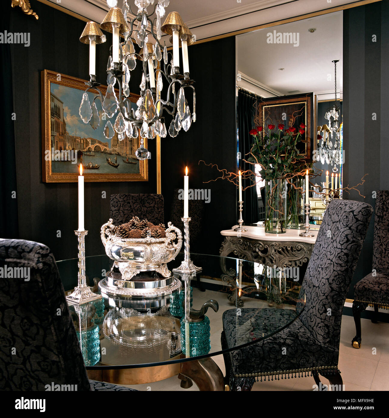 A traditional dining room with round glass table, upholstered chair