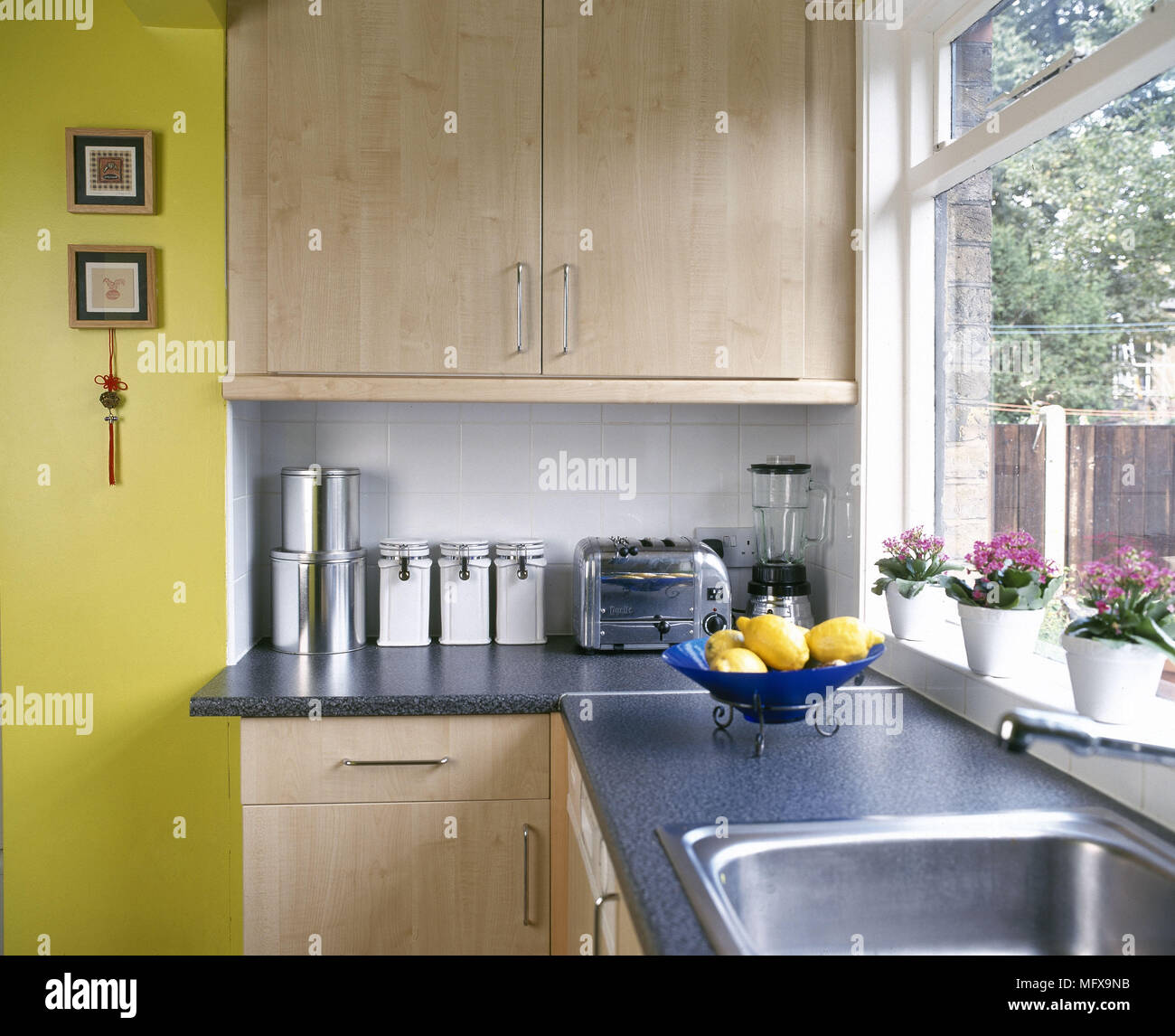 A detail of a modern kitchen wooden units blue granite work top sink Stock  Photo - Alamy