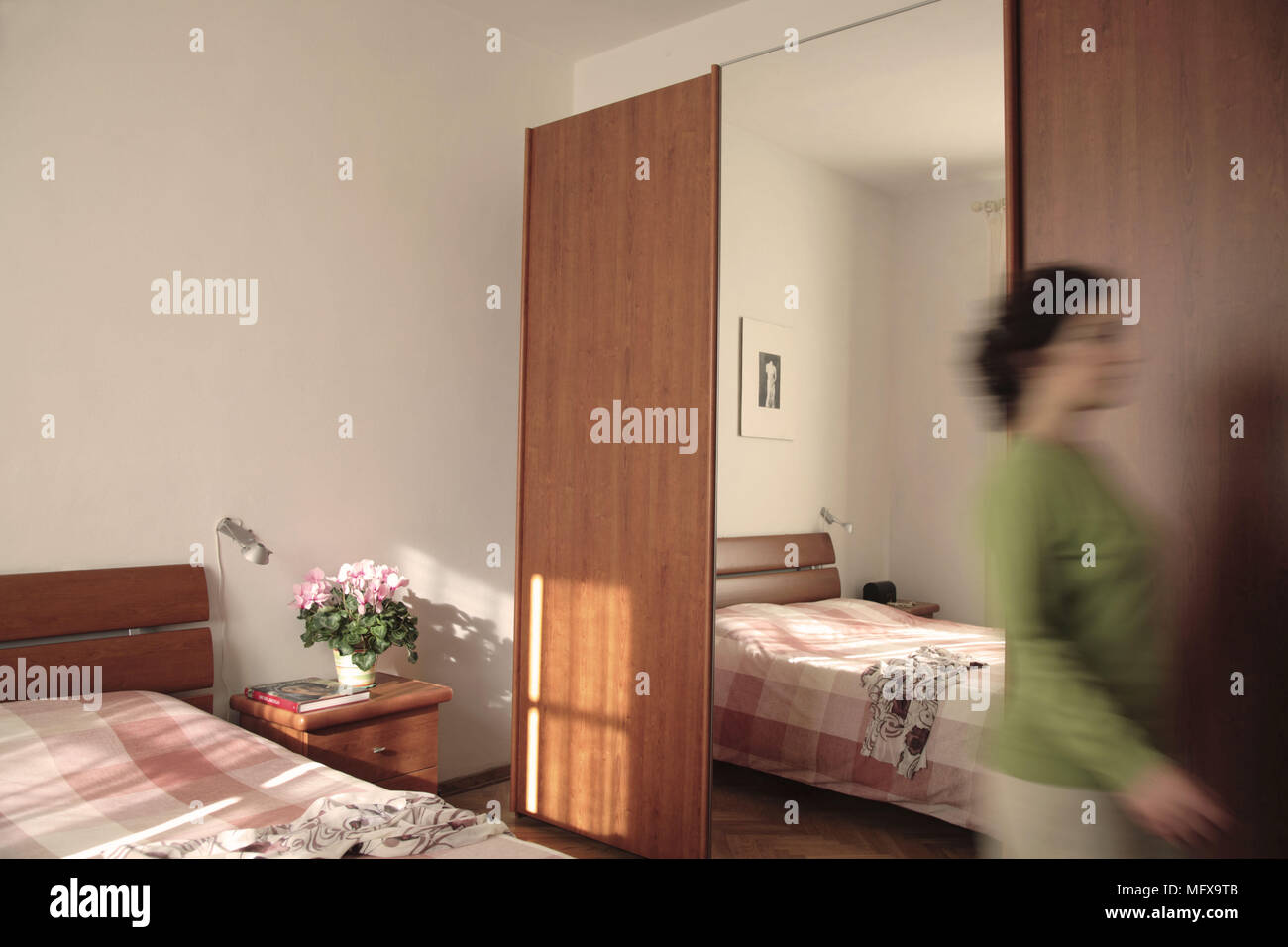 Woman Leaving Bedroom With Built In Wardrobe And Full Length