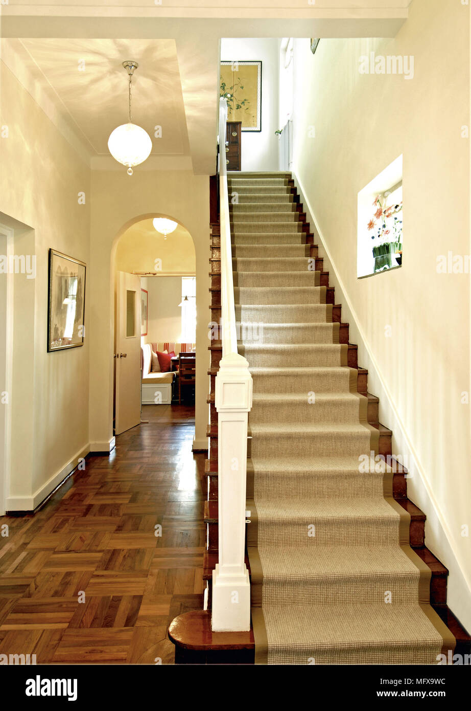 Staircase with carpeted treads in traditional hallway Stock Photo