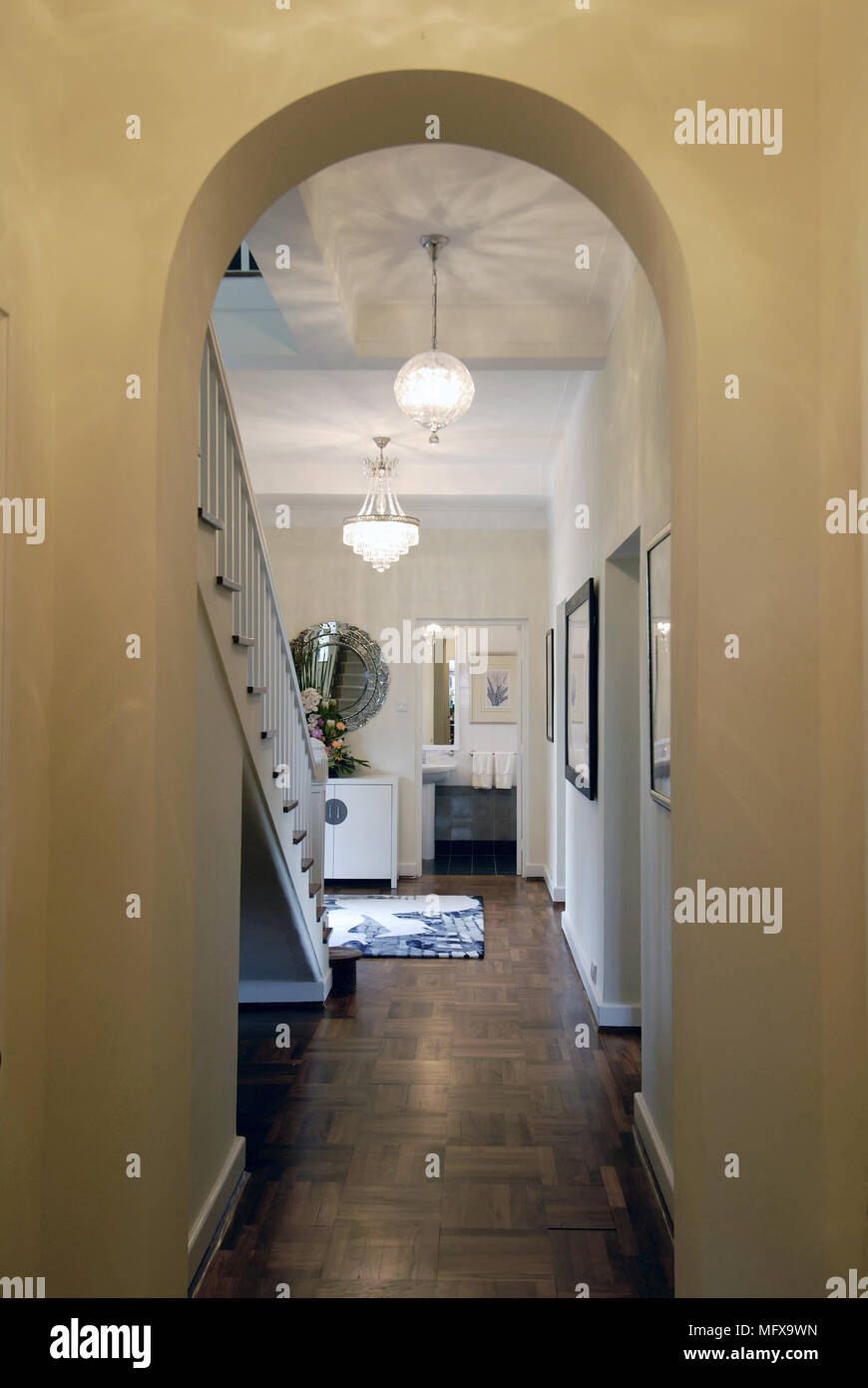 View through archway to modern hallway with staircase Stock Photo