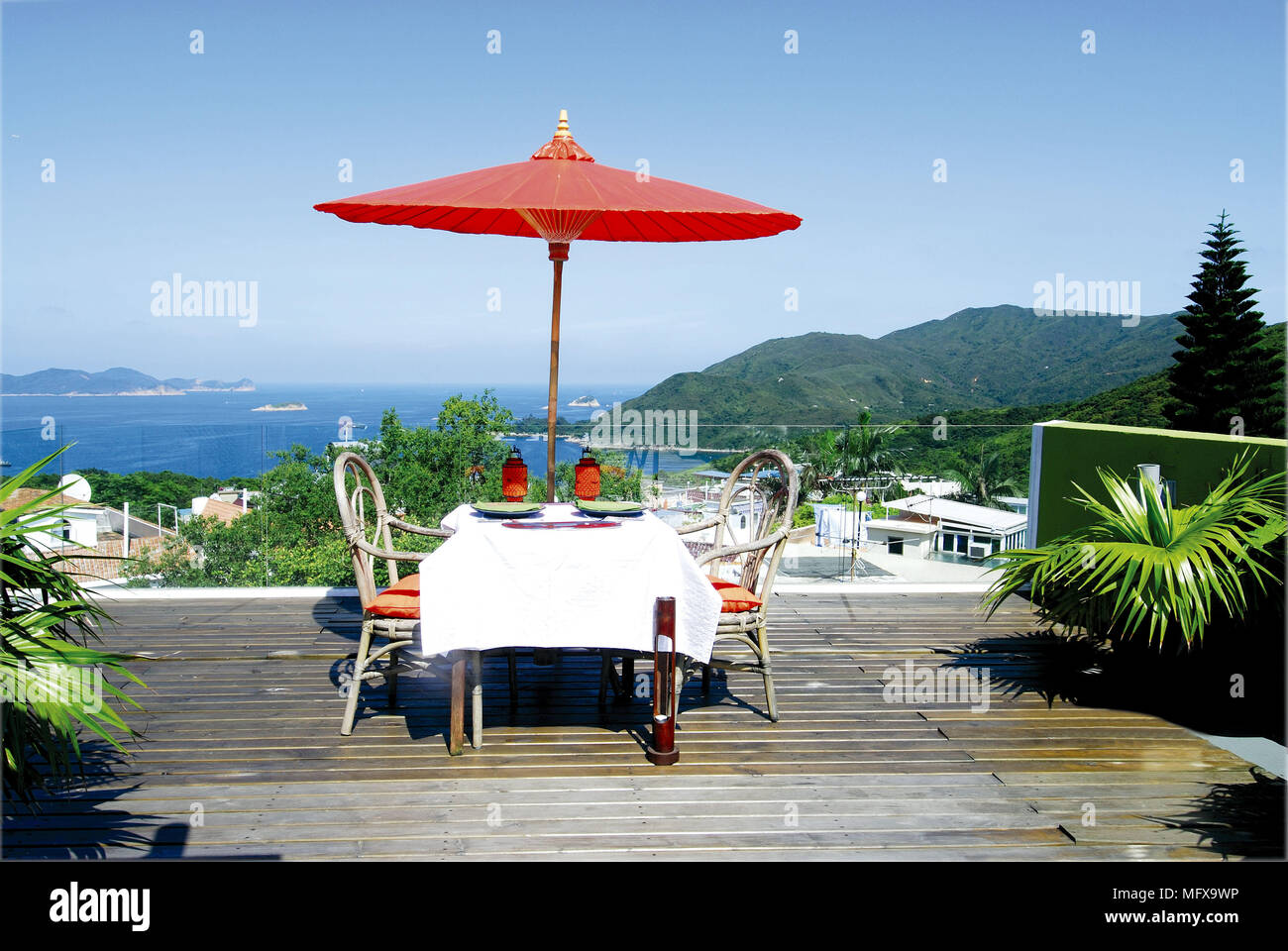 Table for two on decked terrace overlooking ocean view Stock Photo