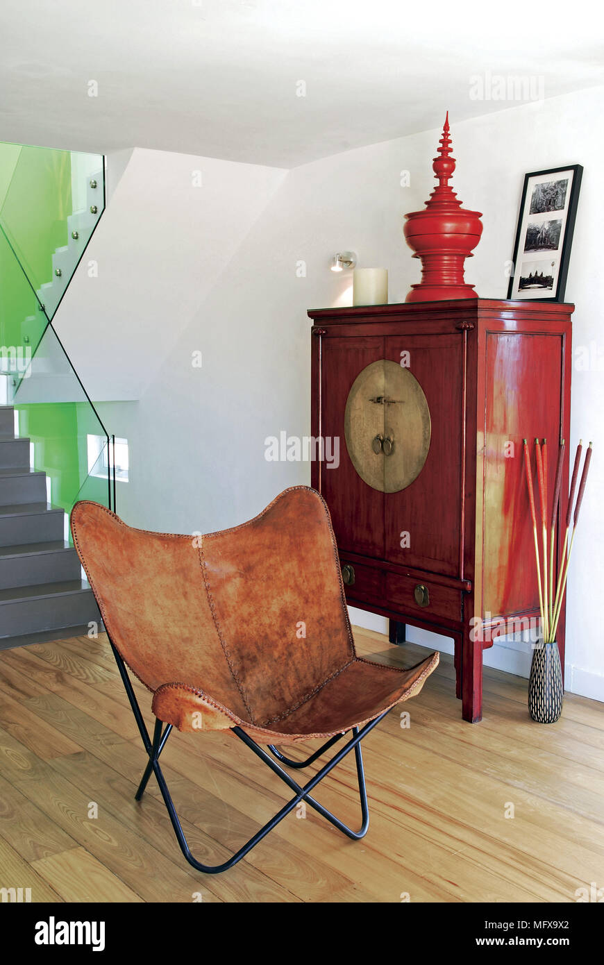 Leather and metal chair in front of Chinese style hallway Stock Photo
