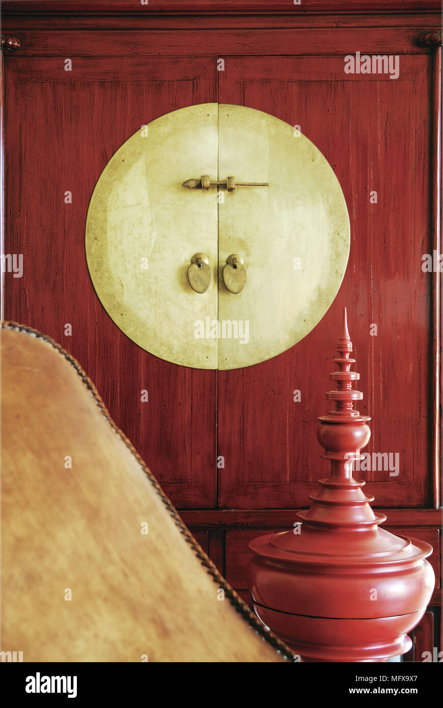 Decorative urn in front of Chinese style cabinet Stock Photo