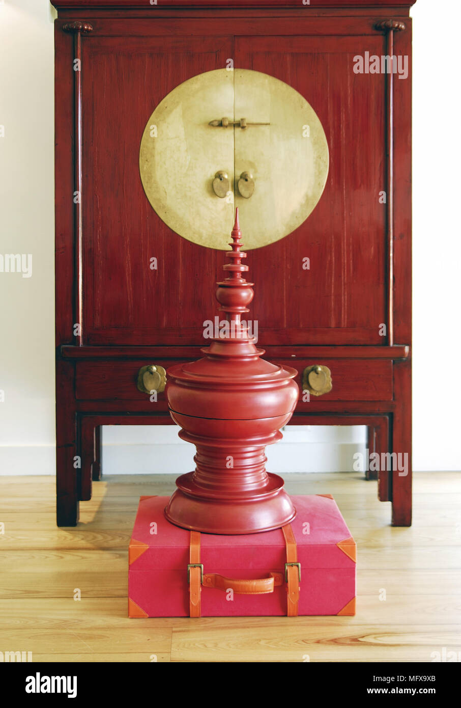 Decorative urn in front of Chinese style cabinet Stock Photo