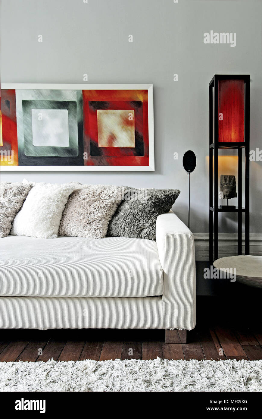 Furry cushions on white sofa in modern sitting room Stock Photo - Alamy