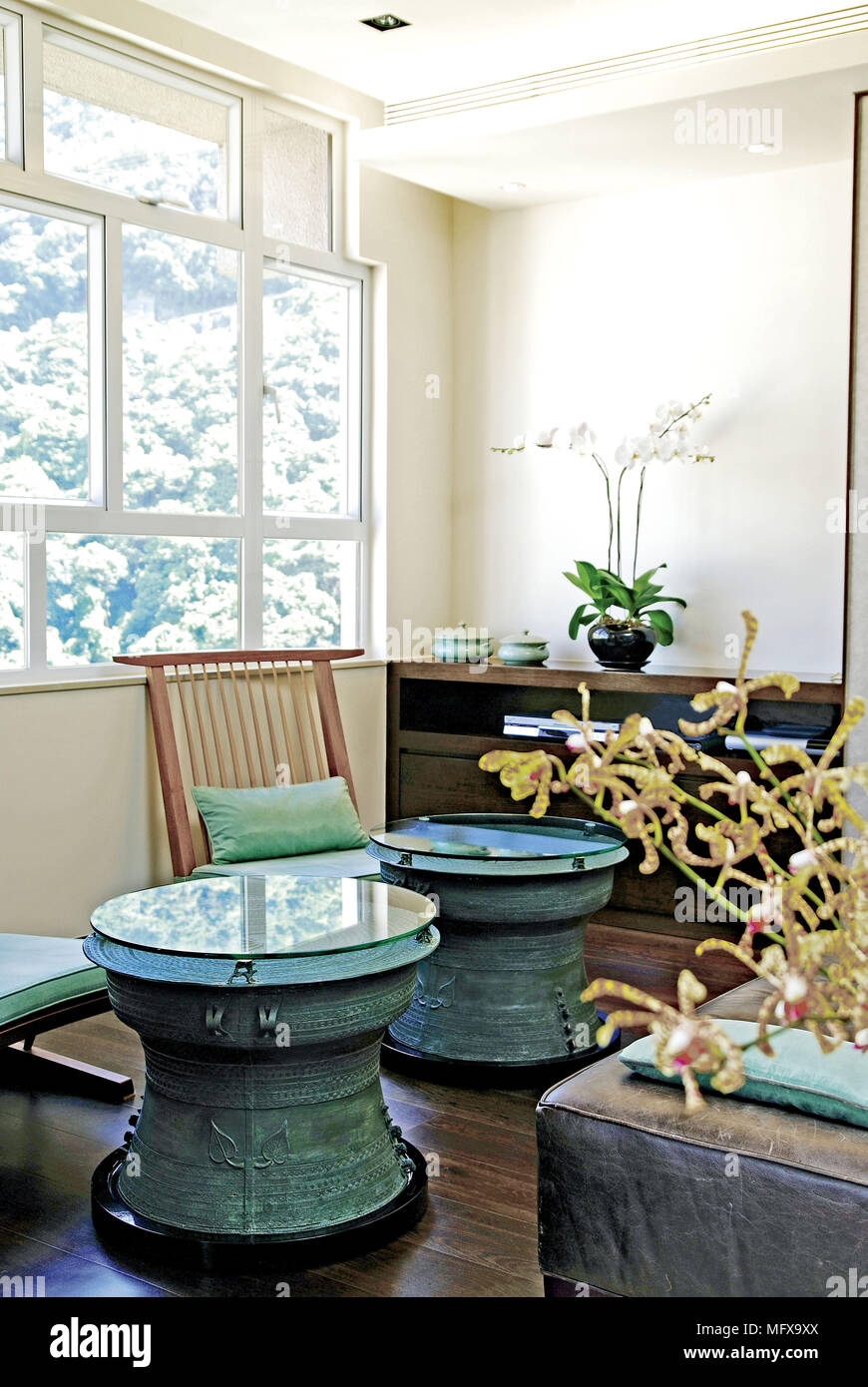 Pair of round tables in ethnic style sitting room Stock Photo
