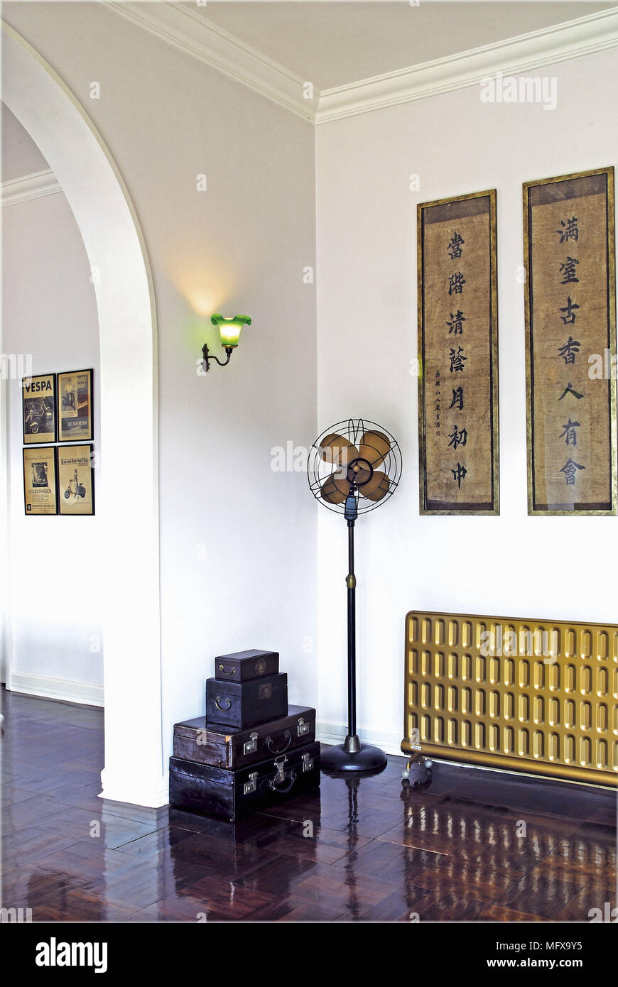 Floorstanding fan next to radiator in ethnic style room Stock Photo