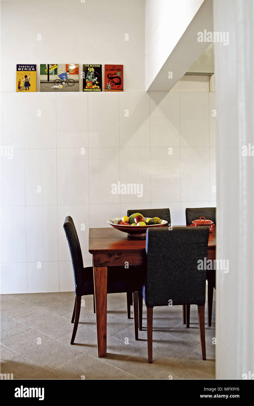 Leather chairs at wooden dining table in modern room Stock Photo