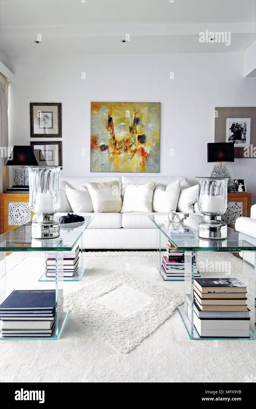 Transparent tables in front of white sofa in modern sitting room Stock Photo