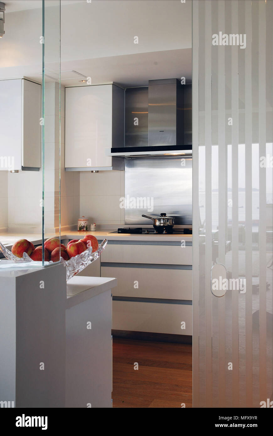 View into modern kitchen with white fitted unit Stock Photo