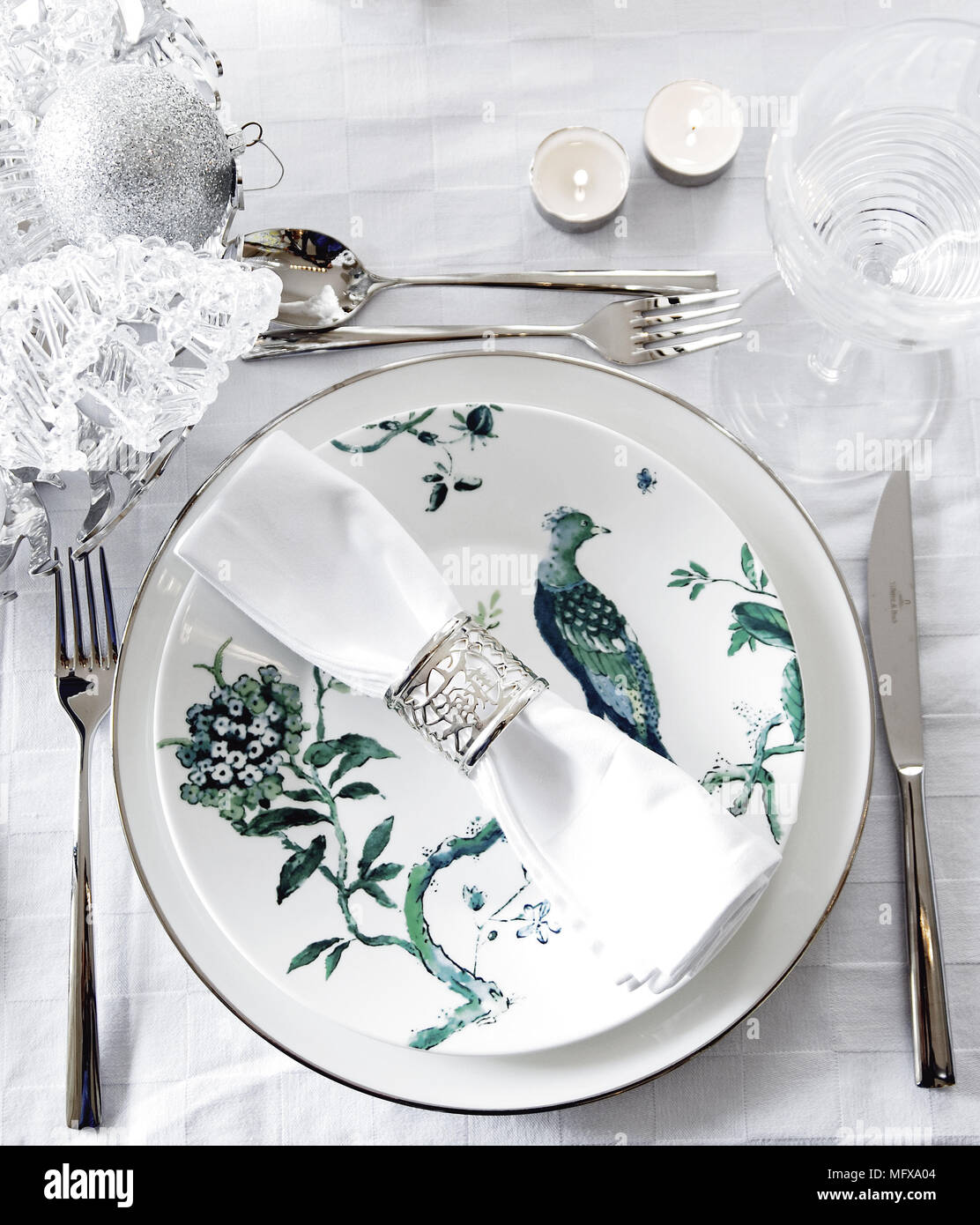 Christmas place setting with white and green tableware Stock Photo