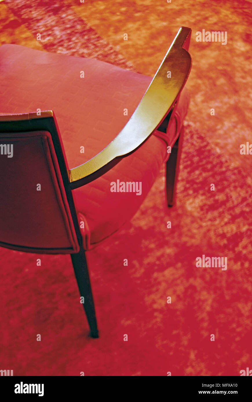Modern chair on red carpet Stock Photo