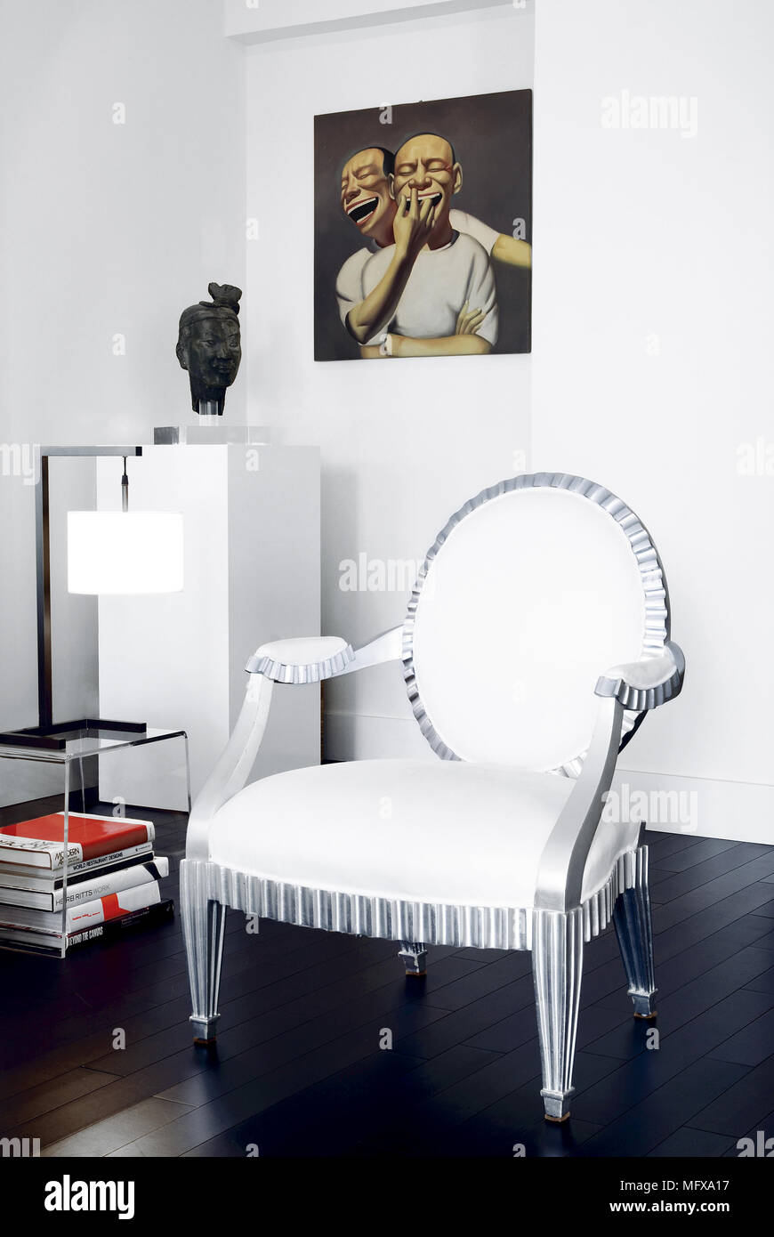 Period style chair next to glass side table in modern room Stock Photo