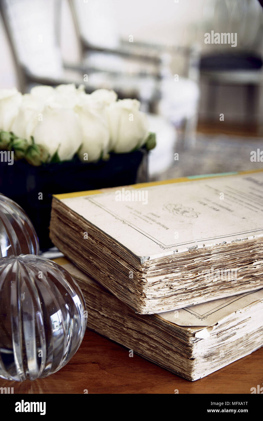 Glass orbs next to antique books Stock Photo