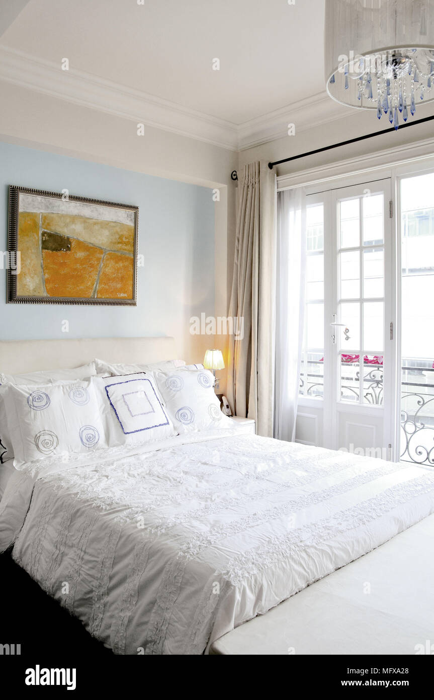 Double bed in traditional style pale blue bedroom Stock Photo