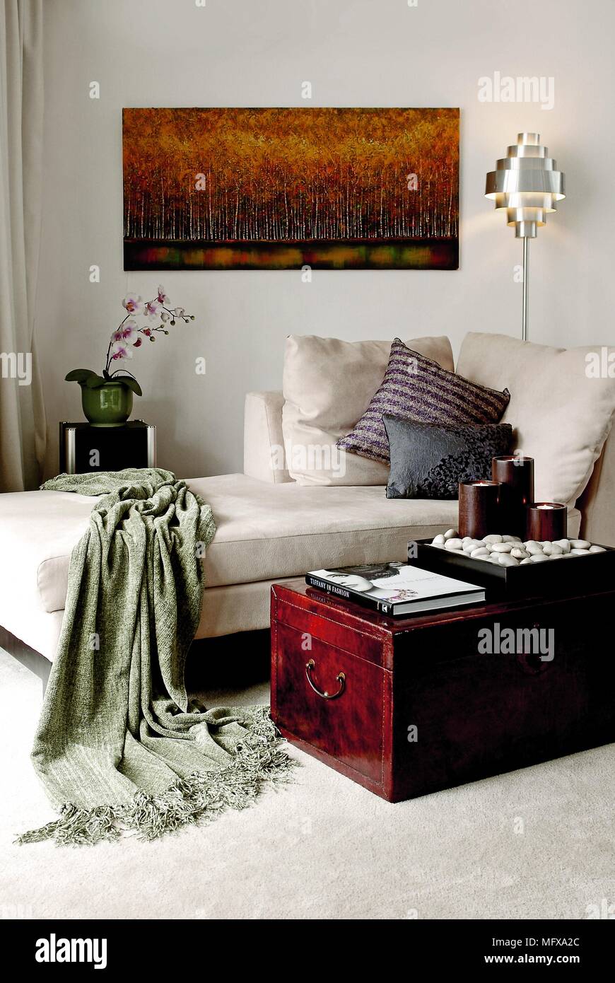 Wooden trunk in front of chaise longue in traditional style sitting room Stock Photo
