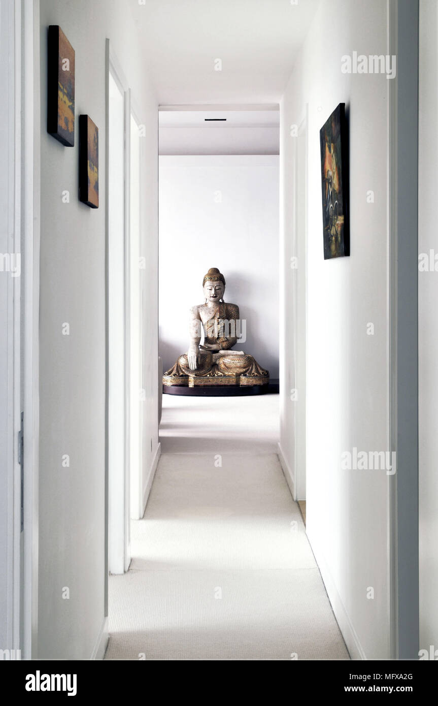 View along hallway to Buddha figure Stock Photo