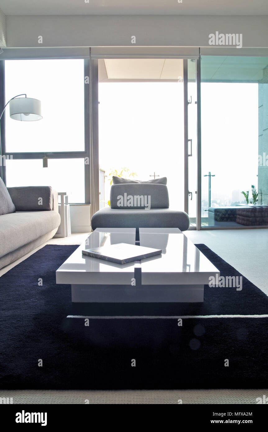 White coffee table in front of seating in modern sitting room Stock Photo
