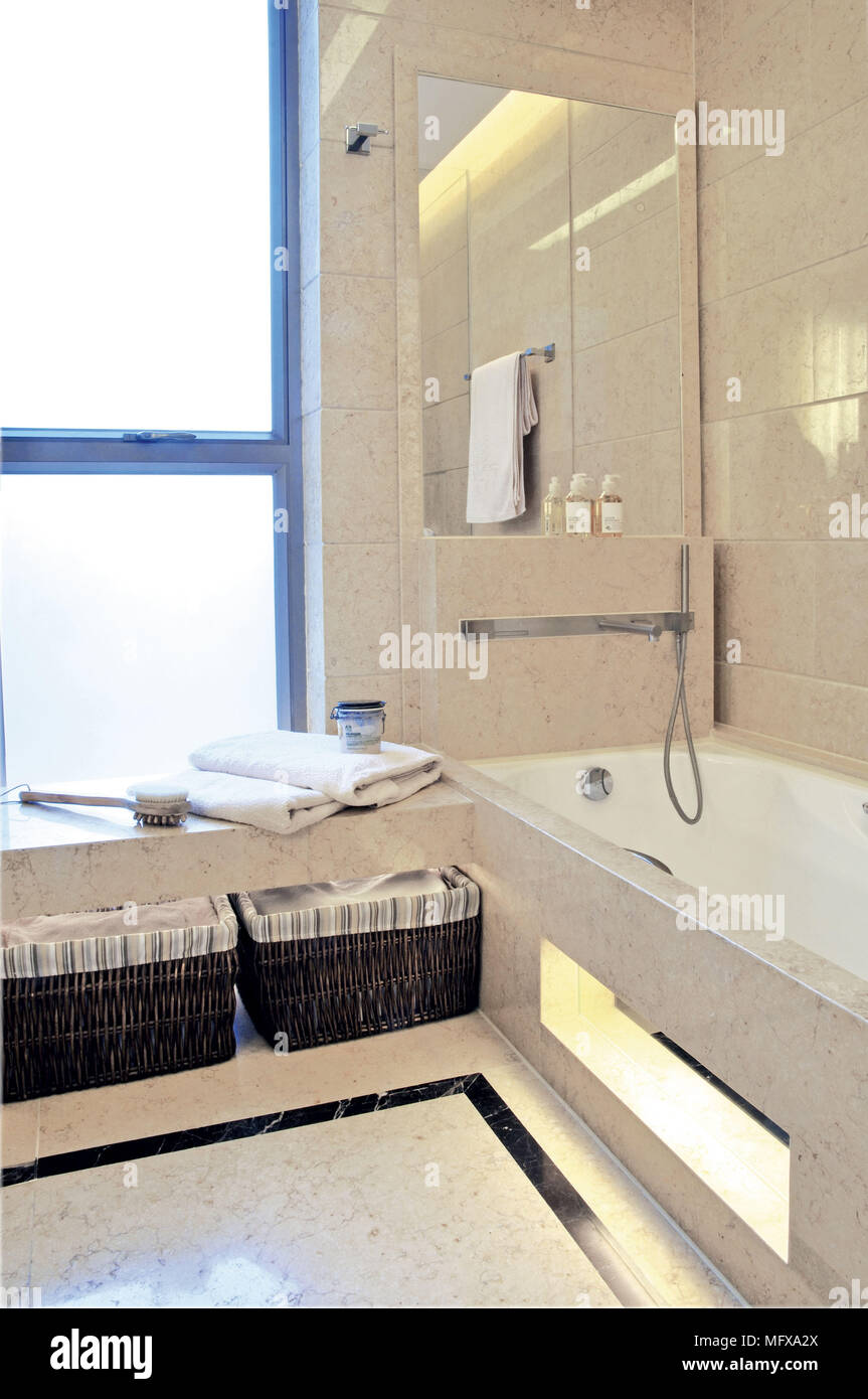 Bathtub in corner of modern bathroom Stock Photo
