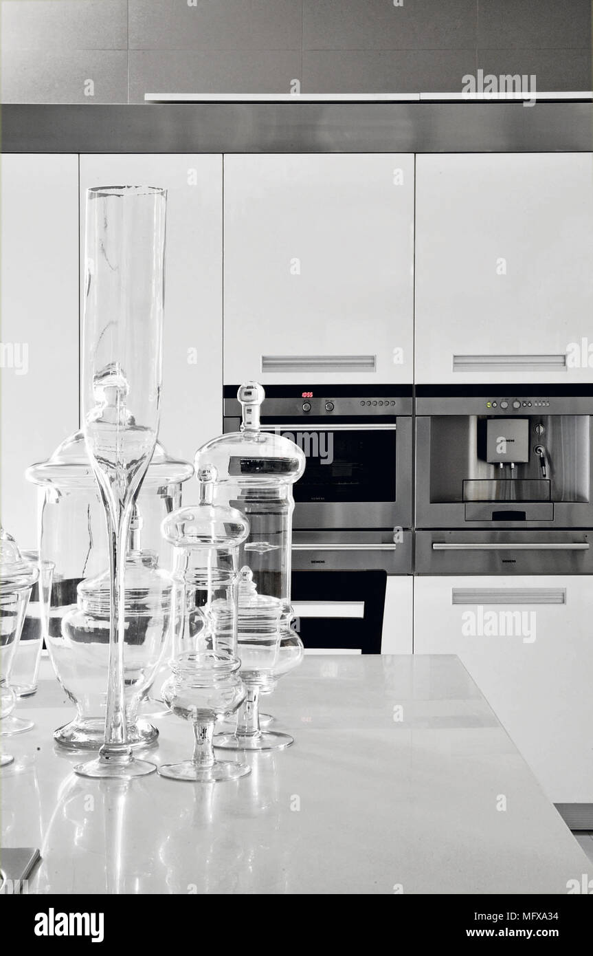 Collection of glassware on central island unit in modern kitchen Stock Photo